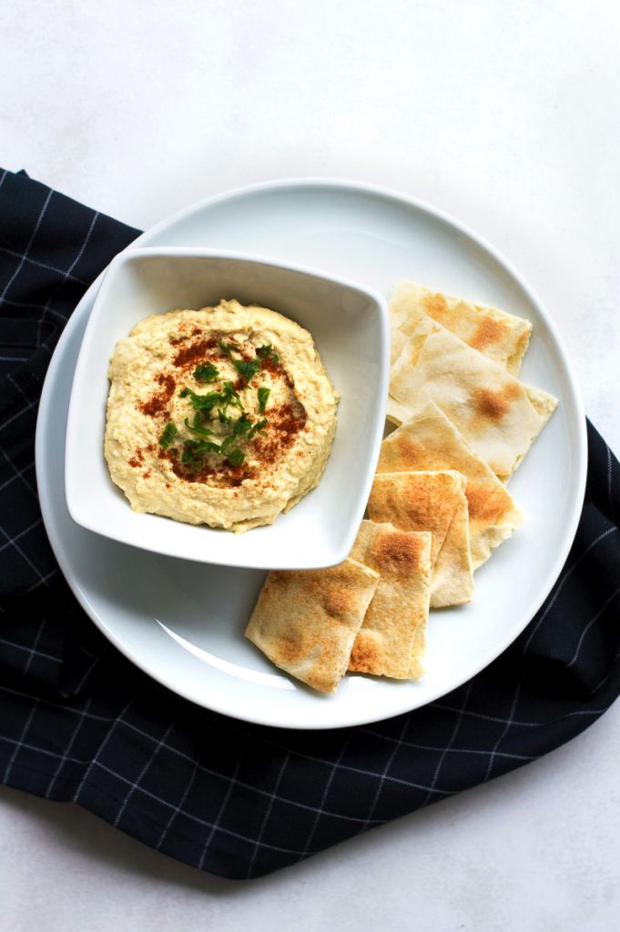 bowl of hummus served with flat bread