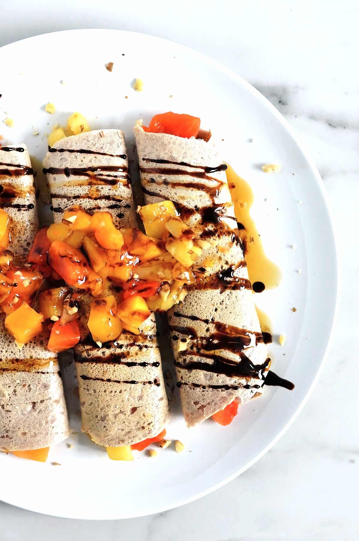 gluten-free buckwheat crêpes topped with fruit and molasses
