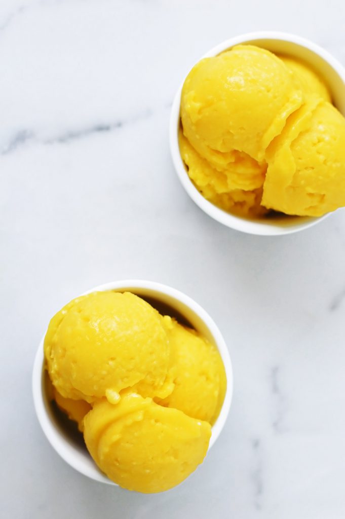 homemade mango ice cream in a white bowl
