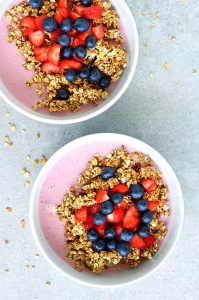 oil-free granola and homemade strawberry yogurt in a white bowl