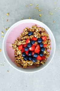 oil-free granola and homemade strawberry yogurt in a white bowl