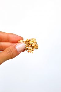 holding a piece of oil-free granola